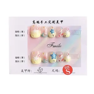 Handmade press-on nails with pastel gradient finish, star motifs and glitter detail