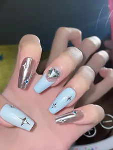 Close-up of Y2K coffin press-on nails in light blue and silver with heart rhinestones