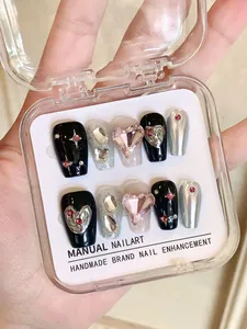 Close-up of handmade press-on nails with heart gems and silver glitter in a clear case