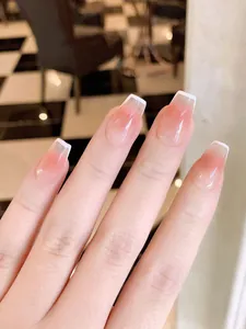 Nahaufnahme von rosa Ombré-Kunstnägeln mit feinen weißen französischen Spitzen