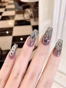 Detailed view of dark grey gradient press-on nails with silver gothic cross and chain
