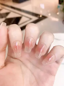 Detail of long coffin press-on nails with pink ombre gradient and aurora powder finish