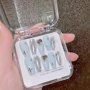 Handmade press-on nails set in silver and light blue with sparkly heart crystals and stars