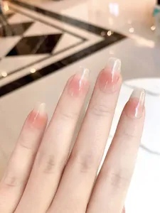 Macro detail of glossy pink gradient press-on nails with ice-like translucent finish