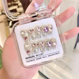 Handmade silver glitter press-on nails set with pink heart rhinestones and silver stars