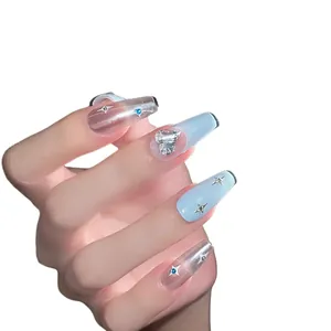 Blue cat eye press-on nails with silver heart rhinestones and glitter star patterns