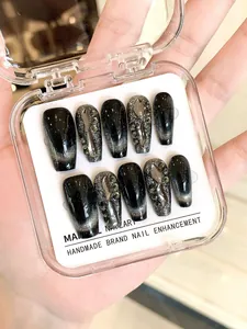 Macro detail of handmade black cat-eye press-on nails with silver 3D metal and crystals