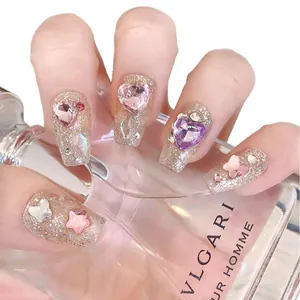 Sparkly dreamcatcher press-on nails with pink 3D hearts and white butterfly accents