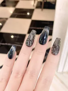 Detail of dark blue cat eye press-on nails with luxury 3D crystal water droplets