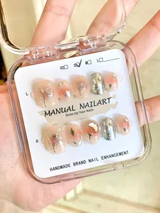 Handmade press-on nails with liquid butterfly design and sparkling rhinestones