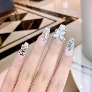Handmade Baroque press-on nails featuring 3D crystal butterfly and pearl bear accents