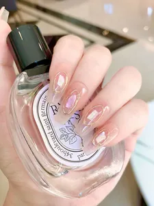 Detailed view of long coffin press-on nails with gold outlines and iridescent shell inlays