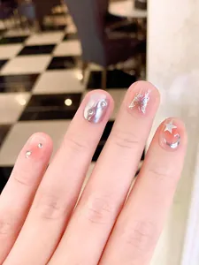 Pink gradient press-on nails with silver liquid butterfly and glitter star accents