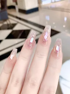 Close-up of handmade press-on nails with purple glitter and golden metal frame accents