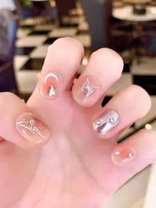 Handmade press-on nails featuring silver liquid butterfly designs and shiny star moon accents