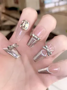 Detail of coffin press-on nails with silver chrome finish and luxury rhinestone accents