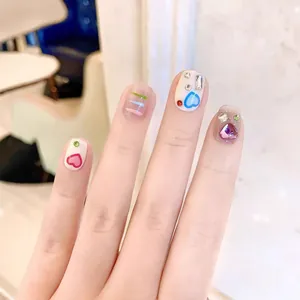 Handmade Y2K press-on nails with colorful heart patterns and sparkling rhinestones