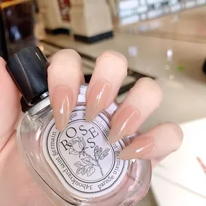 Handmade almond press-on nails in translucent nude tone with a high-gloss finish