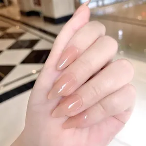 Elegant long almond press-on nails in translucent nude pink with a high glossy finish