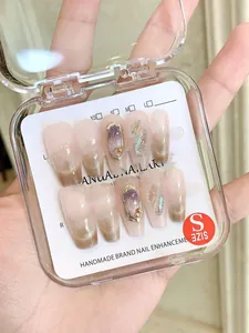 Detail of handmade press-on nails in size S with pearls and aurora glitter finish