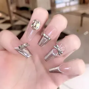 Silver mirror press-on nails with luxury rhinestones and metallic bow in coffin shape