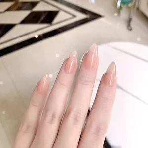 Glossy nude pink gradient press-on nails in long almond shape with a translucent finish