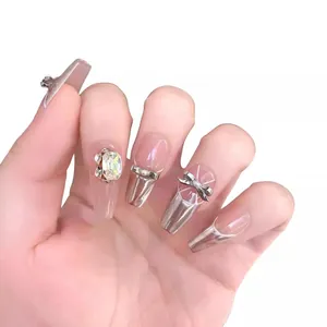 Sparkly ballerina press-on nails with silver glitter, rhinestones, and 3D bow accents