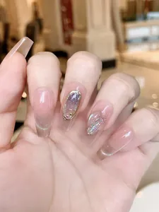Detail view of handmade press-on nails with cat-eye aurora effect and 3D bow accents