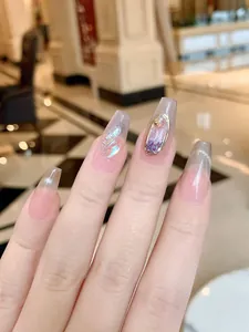 Macro detail of handmade cat-eye press-on nails with luxury glitter and purple accents