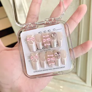 Handmade ballerina press-on nails with pink bows, pearls and sparkling rhinestones