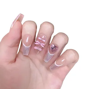 Pink ballerina press-on nails with 3D bows, rhinestones, and French tips on hands