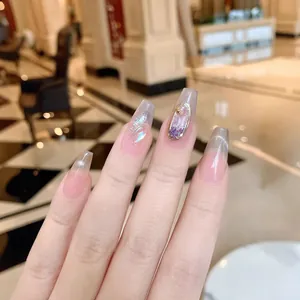Cat eye aurora press-on nails with glitter stones and soft pink gradient coffin shape