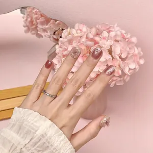 Pink and wine red press-on nails with 3D floral accents, pearls, and glitter finish