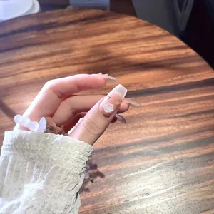 Handmade sheer nude blush press-on nails with 3D embossed roses and gold foil flakes
