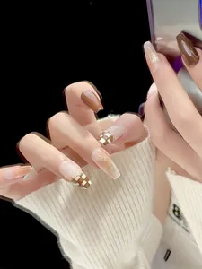 Detail of amber checkerboard handmade press-on nails in long coffin shape for autumn style