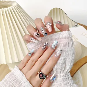 Handmade press-on nails in long coffin shape with glitter, rhinestones and pearls