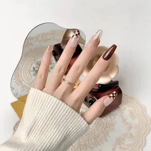 Brown and nude coffin press-on nails with checkered pattern and gold foil accents