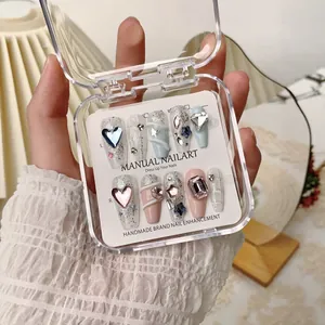Handmade press-on nails with sparkling rhinestones and mixed pastel colors in a gift box