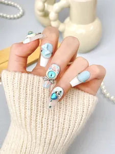 Detail of light blue handmade press-on nails with 3D bows and pearls on a coffin shape