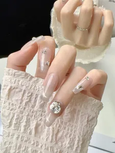 Detail of pink cat eye coffin nails with sparkling rhinestones and hand-crafted finish