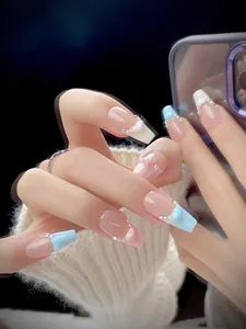 Detailed view of long French press-on nails with blue and pink contrast and 3D hearts
