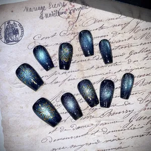 Deep blue cat-eye press-on nails with golden fireworks on vintage French letters