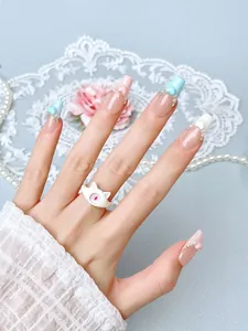 Detailed view of ballerina press-on nails with 3D hearts and pearls in a sweet design