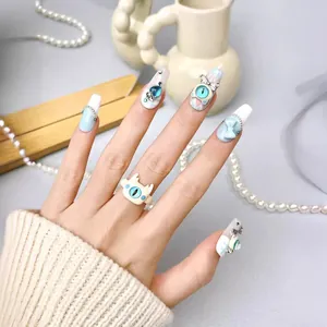 Blue and white handmade press-on nails with bow accents and matching opal cat-eye ring