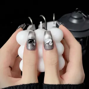 Silver cat eye press-on nails with 3D Barbie-style logo in long trapezoid shape