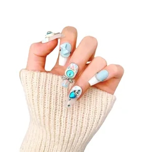 Handmade coffin nails in light blue and white with 3D bows and sparkling rhinestones