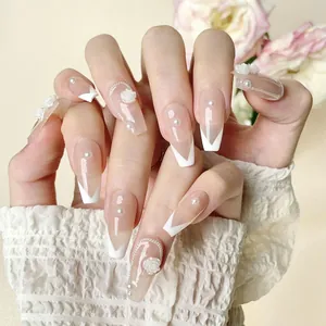 Handmade nude press-on nails with 3D camellia flowers, pearls and French tip design