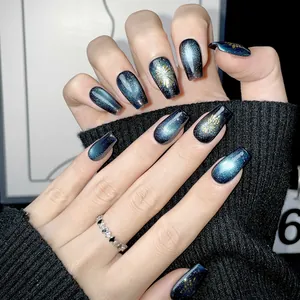 Blue cat eye press-on nails with gold fireworks pattern in long ballerina shape