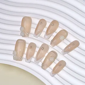 Handmade nude pink press-on nails with white French tips, camellia flowers and pearls