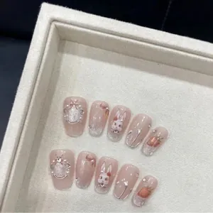 Handmade Rococo press-on nails with 3D bunny, strawberry and pearl accents on pink base
